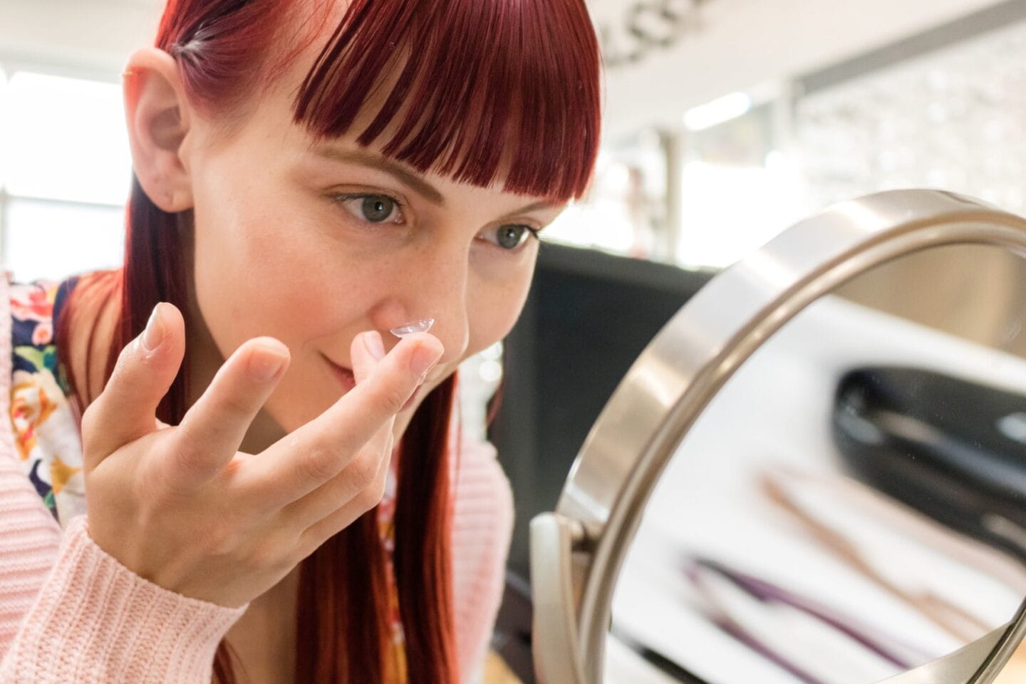 woman inserting daily contact lenses, dailies contact lens brand