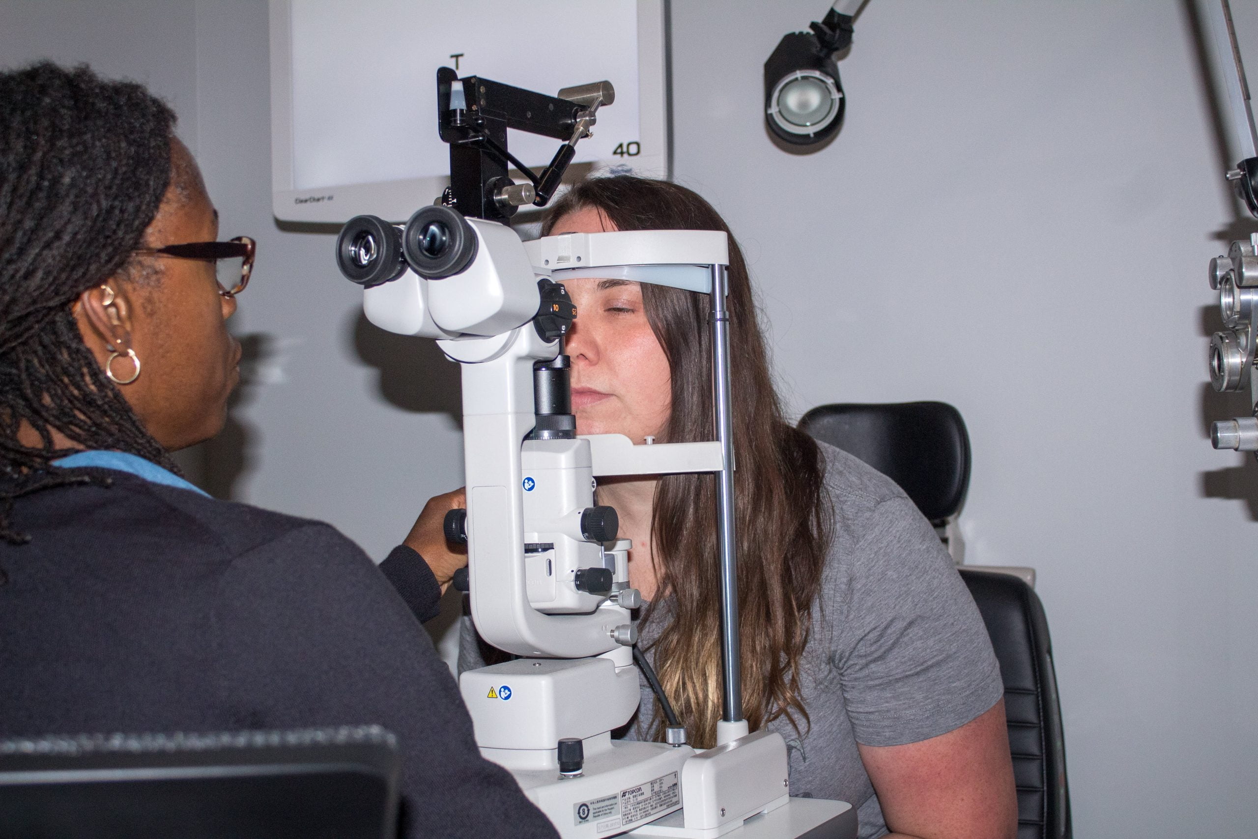 woman getting her eyes checked by optometrist