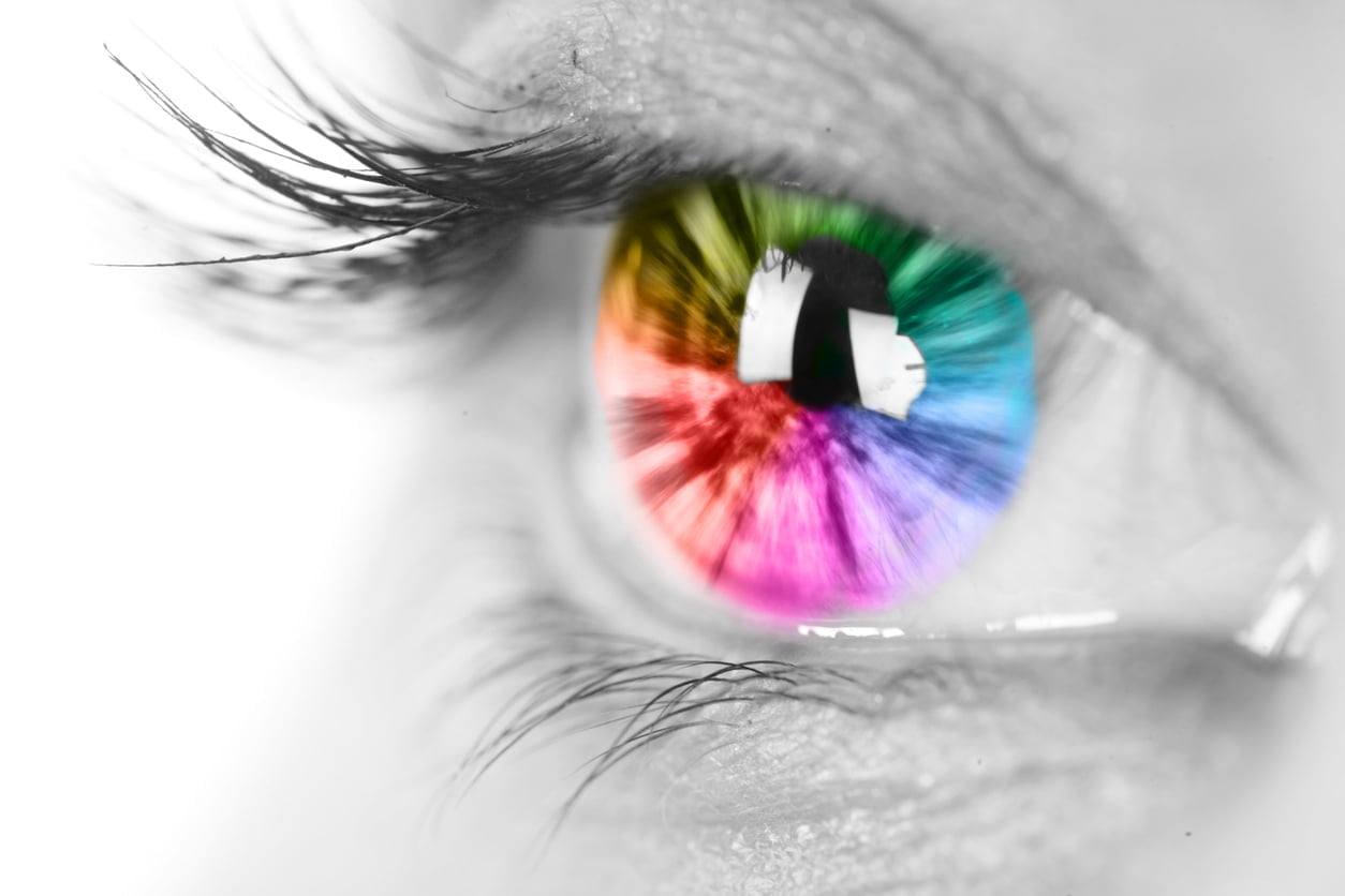 close up of eye with rainbow multicolored iris