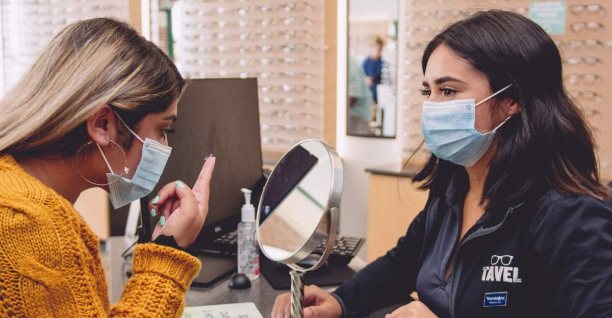 How to avoid eye infections from contacts, woman trying on contact with help from an optician