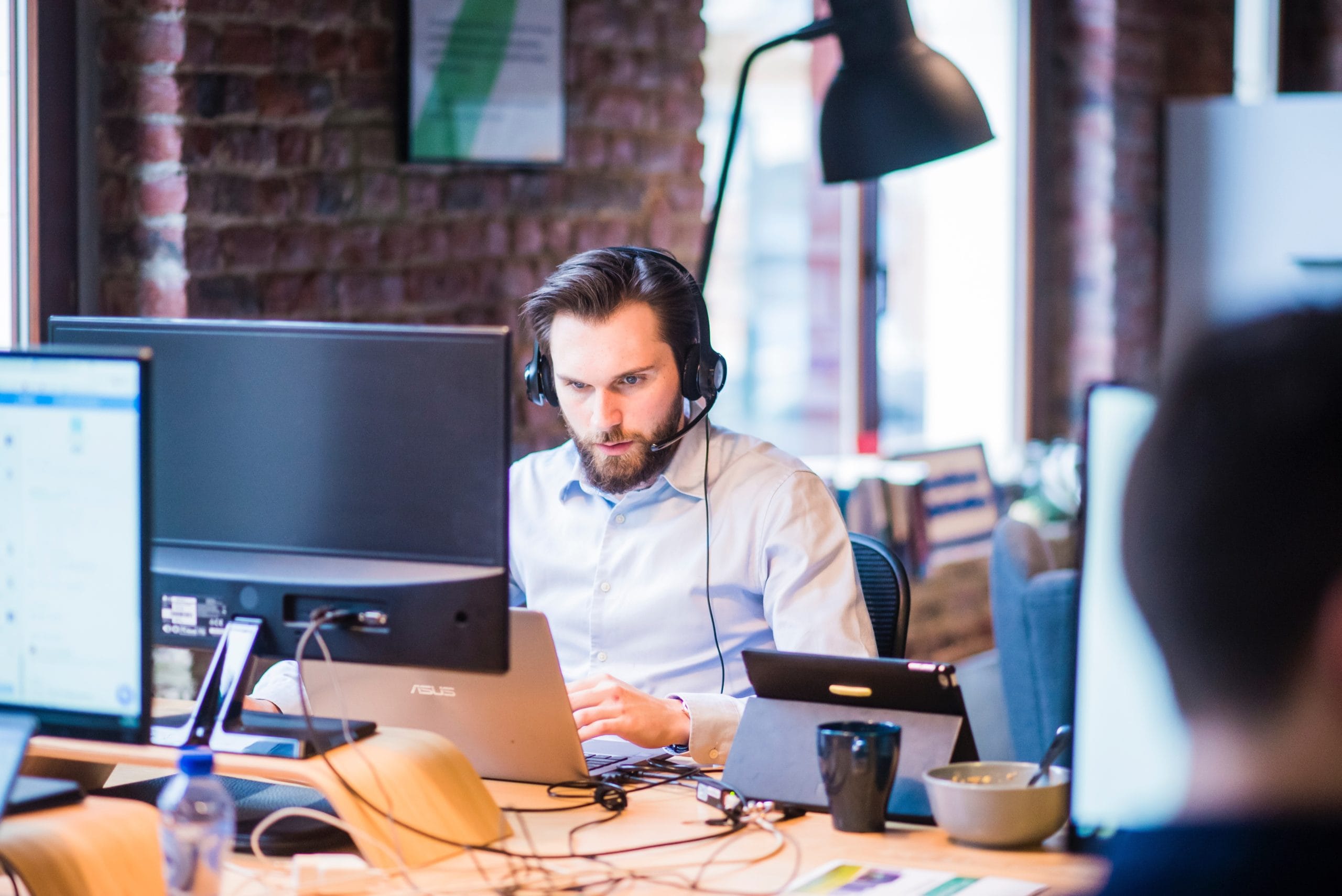 man sitting at desk staring at a computer screen