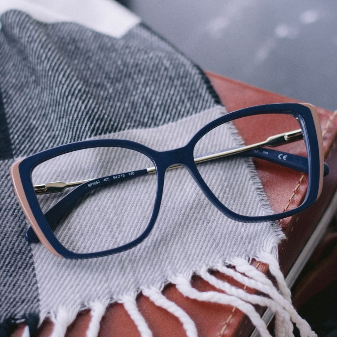 glasses on black and white scarf