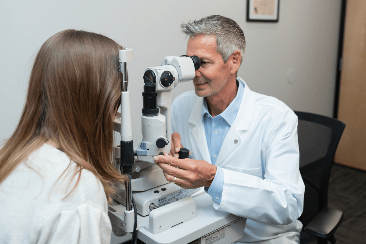 eye doctor using slit lamp on patient during an eye exam