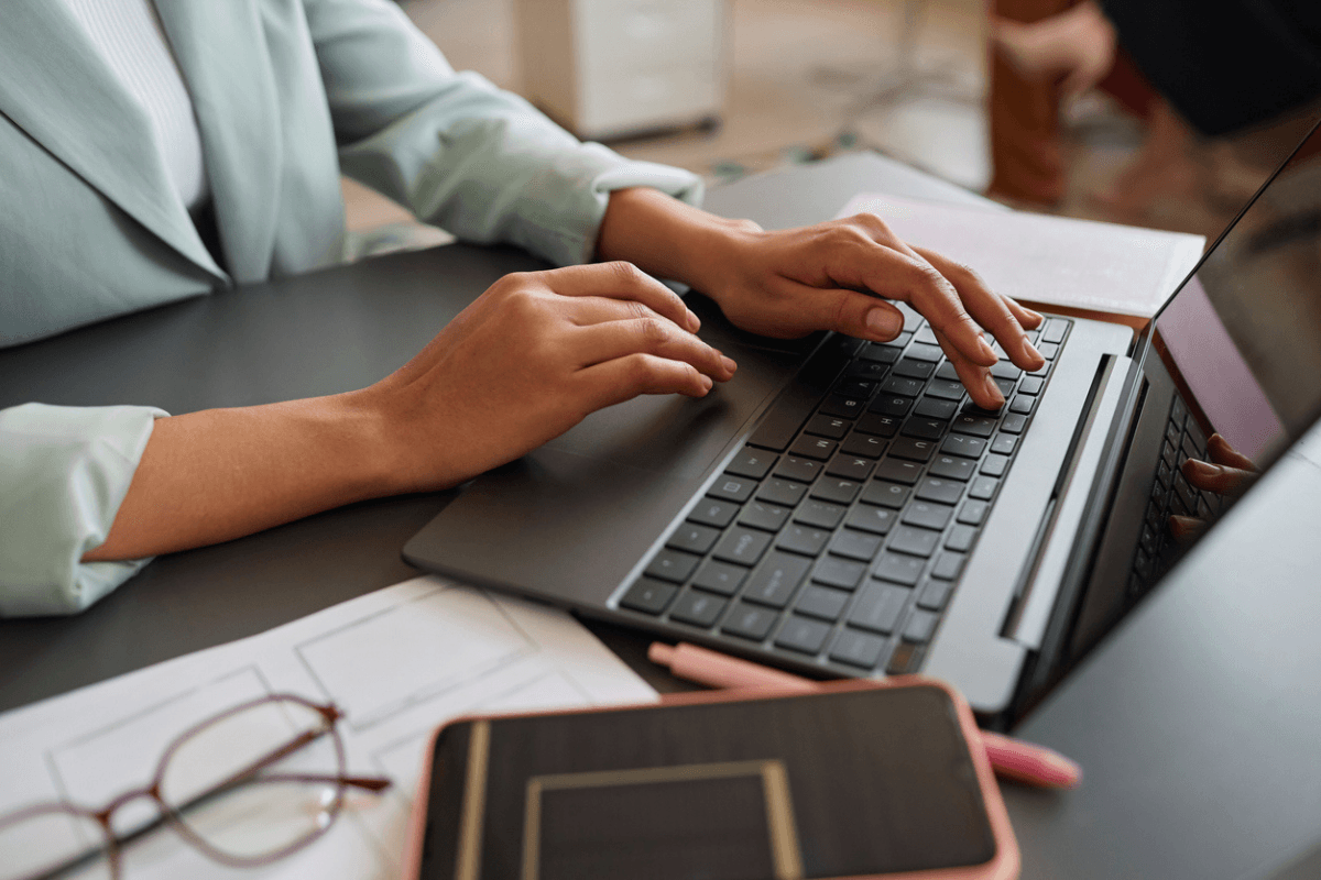 hands typing on laptop