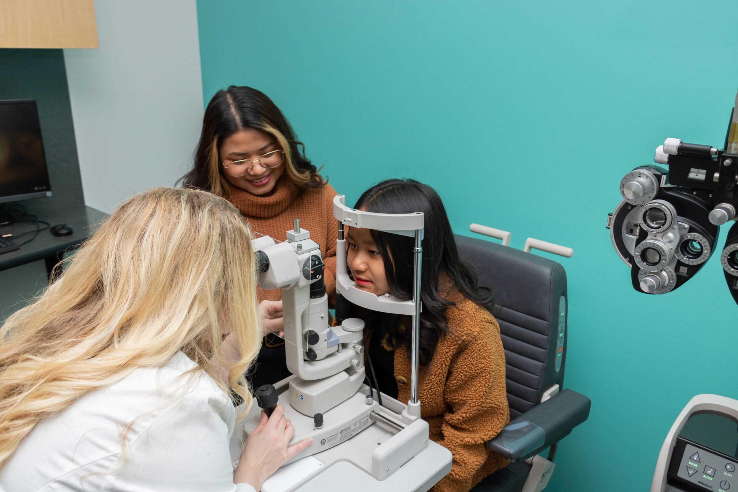 child getting an eye exam with a slit lamp